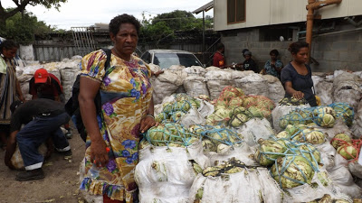 Janet Mose with her bags of cabbages.